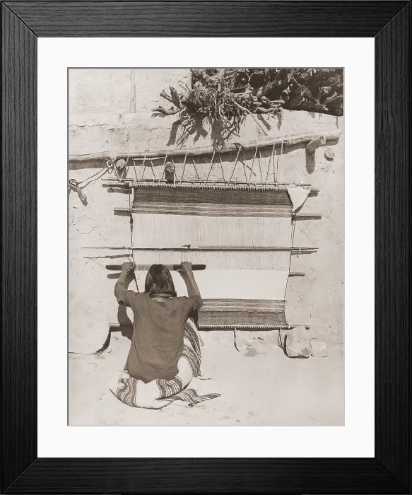 Framed Print : Hopi man weaving a blanket uses a wooden sley, a tool used in weaving to force the weft into place (BSLOC_2019_9_80)