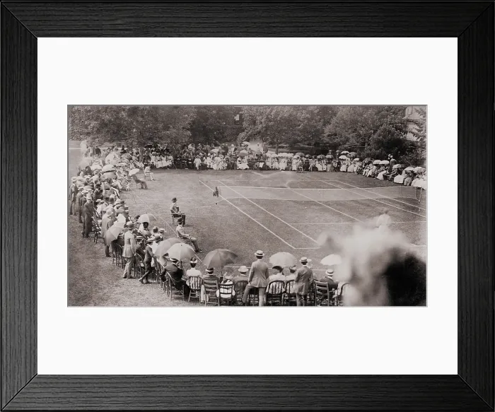 Framed Print : Fashionable spectators are seated around at grass tennis court at the Casino in Newport, RI, c. 1900