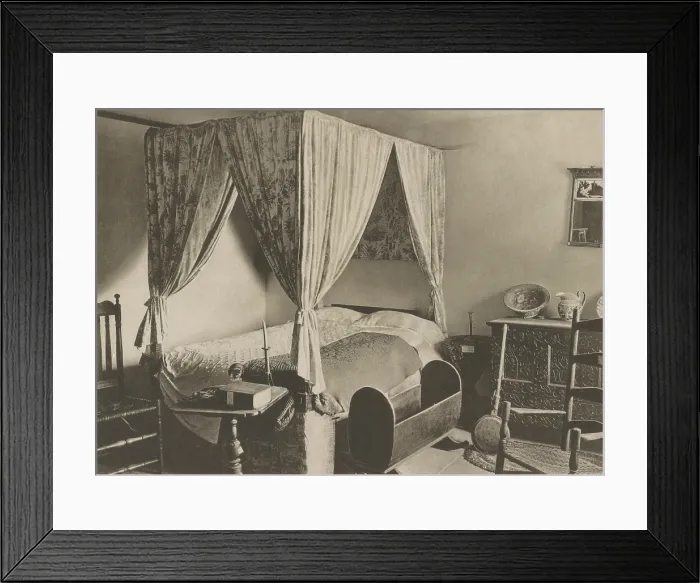 Framed Print : A colonial bedroom in Deerfield, Massachusetts, is furnished with period chairs, chests, bed, textiles, utensils, and cradle. Photo postcard from 1907 (BSLOC_2020_1_177)