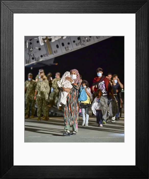 Framed Print : A young Afghan refugee mother carries her bundled child as she walks from the US Air Force C-17 in Sigonella, Italy Framed Print : A young Afghan refugee mother carries her bundled child as she walks from the US Air Force C-17 in Sigonella, Italy