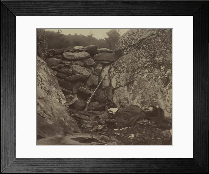 Framed Print : Dead Confederate soldier lies in the Devil's Den, against the wall of stones, with his rifle, on the Gettysburg battlefield, c. July 4-6, 1863