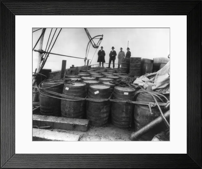 Framed Print : Prohibition agents examining barrels on the captured rum-runner, Tomoka, in Nov. 1924