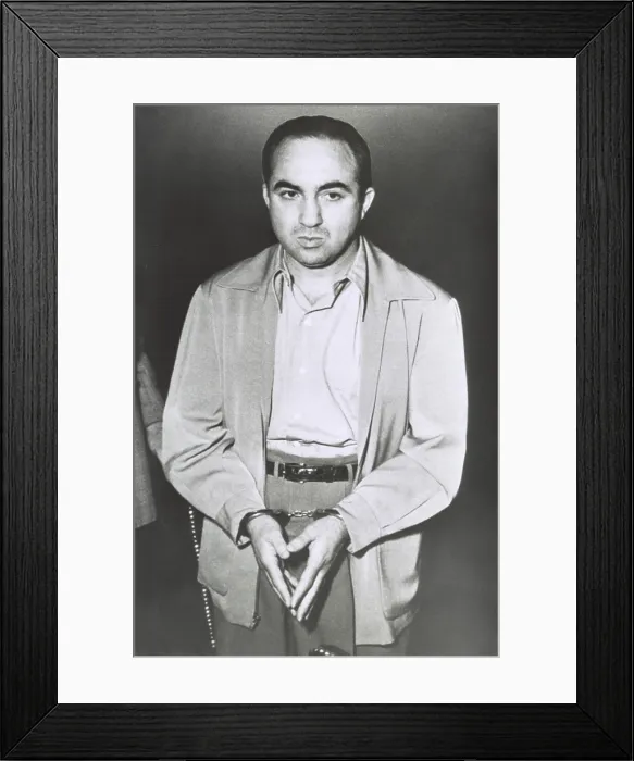 Framed Print : Gambler Mickey Cohen stands handcuffed awaiting his removal from Los Angeles Federal Court. He was sentenced to five years in prison and fined $10, 000 for income tax evasion