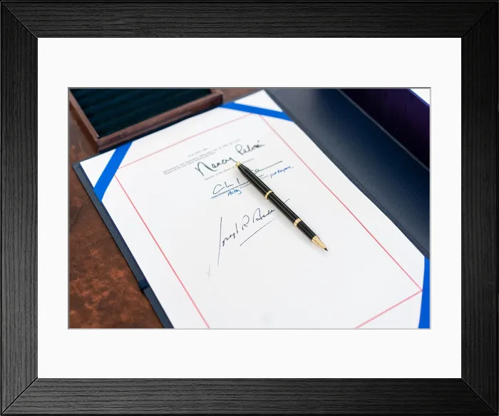 Framed Print : White House staff arranges the signing page and box holding the full text of the American Rescue Plan Act of 2021, on President Joe Biden's Resolute Desk, March 11