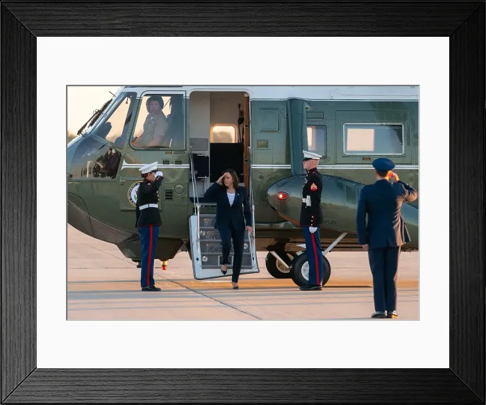 Framed Print : Vice President Kamala Harris salutes US Marines as she leaves Marine Two at Joint Base Andrews, Maryland, June 25, 2021
