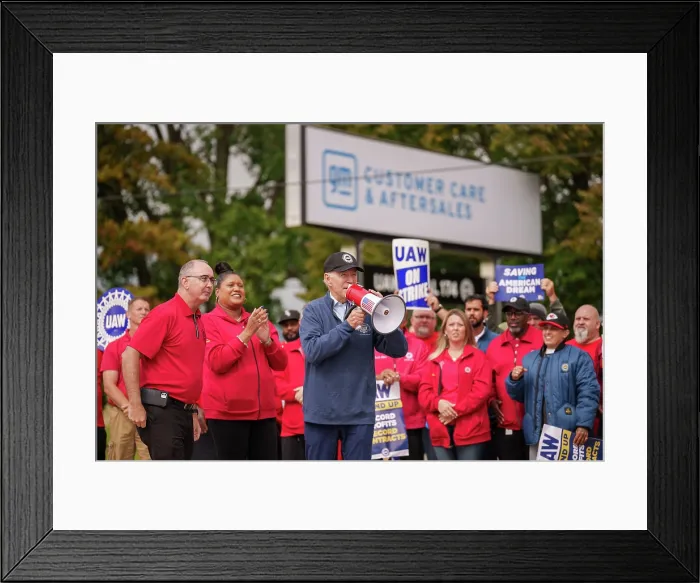 Framed Print : Holding a bullhorn, President Joe Biden addresses UAW members walking a picket line at the GM Willow Run Distribution Center, Sept. 26, 2023, in Belleville, Michigan