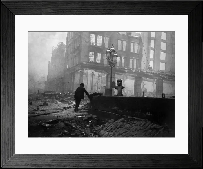 Framed Print : A solitary man walks in the ruins after the April 18, 1906 San Francisco earthquake and 3-day fire. In the foreground is a sunken area on Market Street near Ferry building