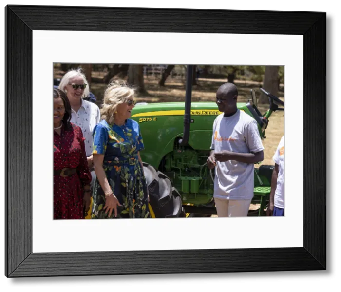 Framed Print : First Lady Jill Biden speaks with a smallholder farmer who leased farm machinery from participation in Hello Tractor, which used updated technology to facilitate tractor