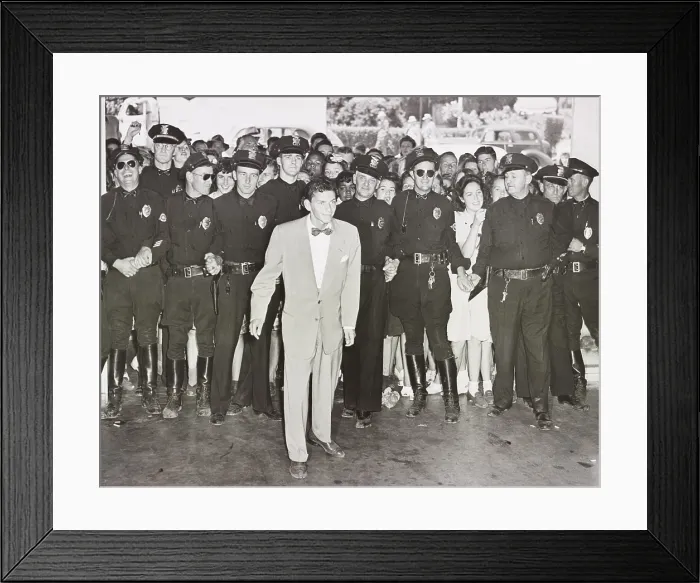 Framed Print : A police line protects Frank Sinatra from a crowd of young fans on his arrival at the Pasadena, California train station, Aug. 11, 1943 (BSLOC_2020_2_1)