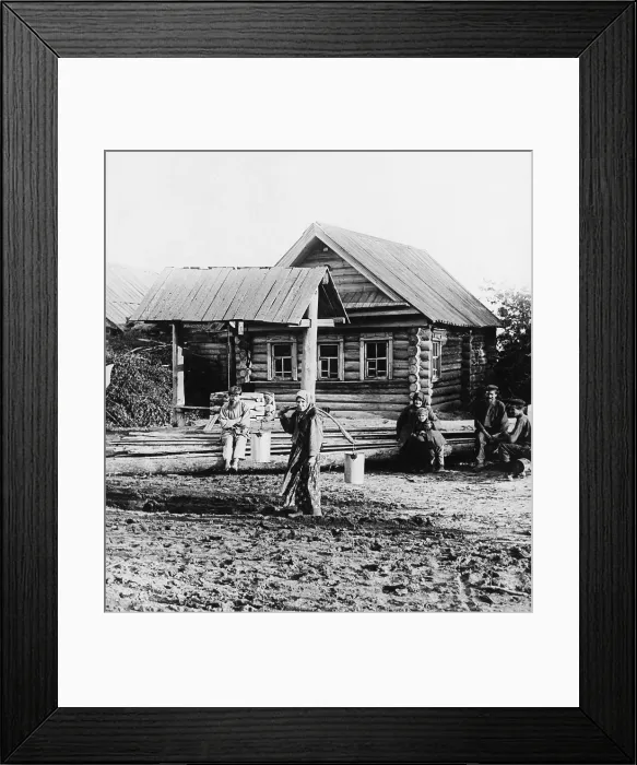 Framed Print : A Russian peasant women carries two pails of water with the aid of a shoulder yoke, ca. 1920. She trudges through mud with felt boots, like those worn by Russia soldiers in WW1