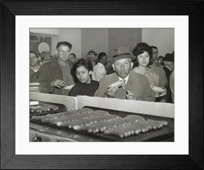 Framed Print : Sol Handwerker eating a Famous Coney Island hot dog at SNACKTIME, his new eatery on 34th Street in Manhattan, Sept. 17, 1963