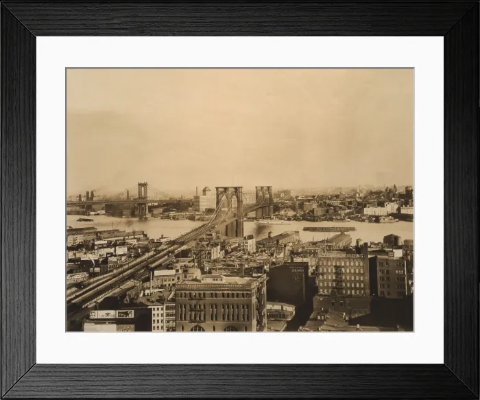 Framed Print : Brooklyn and Manhattan Bridges span the East River 1919. Brooklyn is in the distance and bridge's roadway penetrates several blocks into Manhattan (BSLOC_2018_2_168)