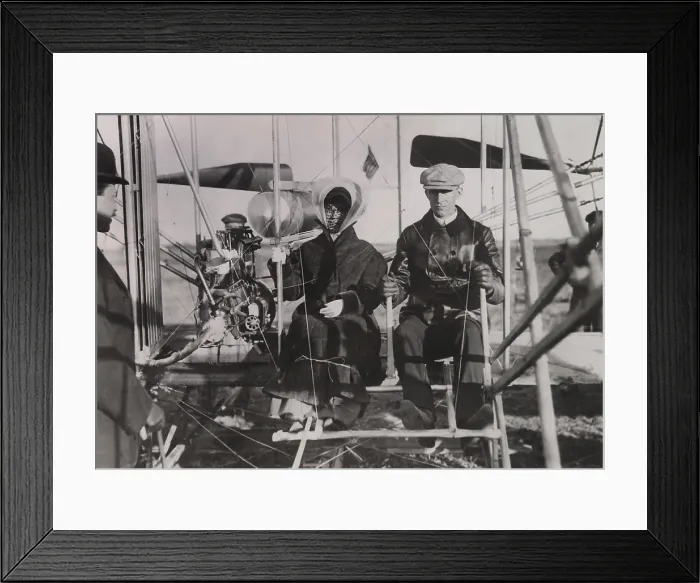 Framed Print : Katharine Wright sits beside brother Wilber at the beginning of her first ride in an airplane. Photo was taken in southern France on Feb. 15, 1909