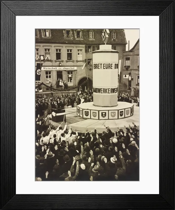 Framed Print : Crowd in Ottweiler, Germany, saluting an unidentified Nazi monument in 1933. Hanging garlands and a swasticka banner decorate the area Framed Print : Crowd in Ottweiler, Germany, saluting an unidentified Nazi monument in 1933. Hanging garlands and a swasticka banner decorate the area