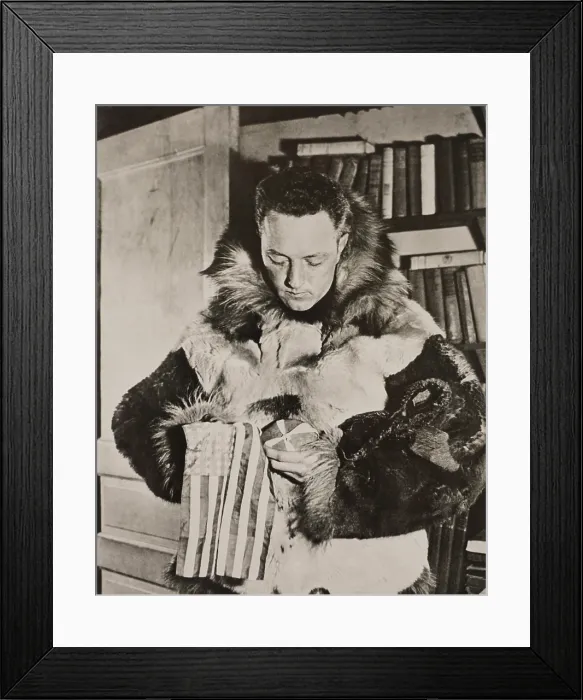 Framed Print : Richard Byrd in polar furs before his flight over the South Pole. He holds a small American flag weighted with a stone from the grave of his colleague and friend, Floyd Bennett