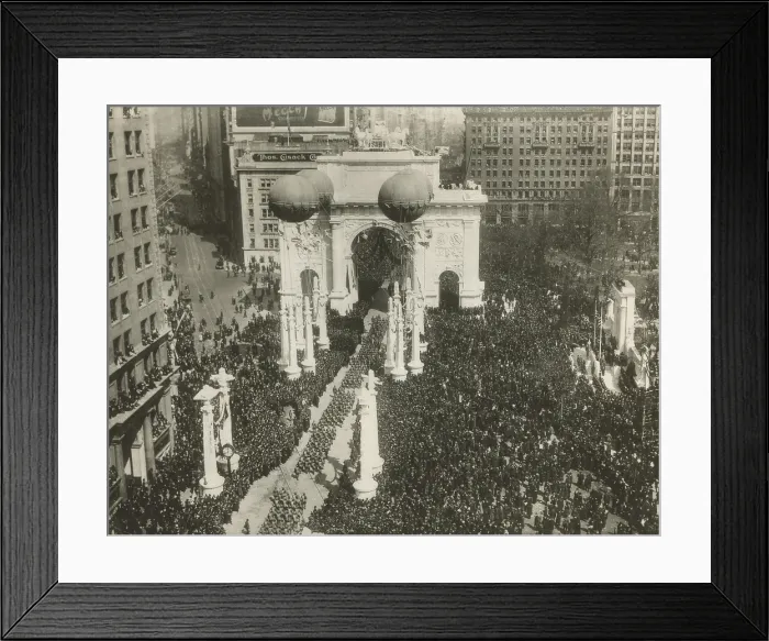 Framed Print : World War I Victory Arch, on Fifth Avenue near Madison Sqaure Park on March 25, 1919. The 27th Infantry Division marches through a Roman styled triumphal as a crowd cheers them
