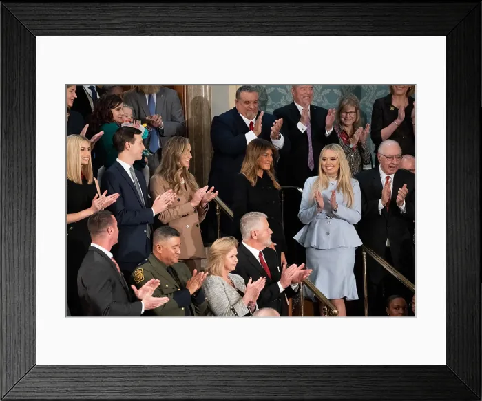 Framed Print : First Lady Melania Trump receives applause as she arrives at the gallery of the House chamber. At right in a pale blue dress, is her step-daughter, Tiffany Trump