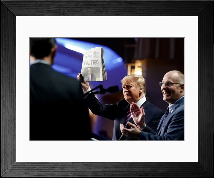 Framed Print : President Donald Trump holds up a USA Today newspaper with the headline ACQUITTED at the National Prayer Breakfast Thursday, Feb. 6, 2020