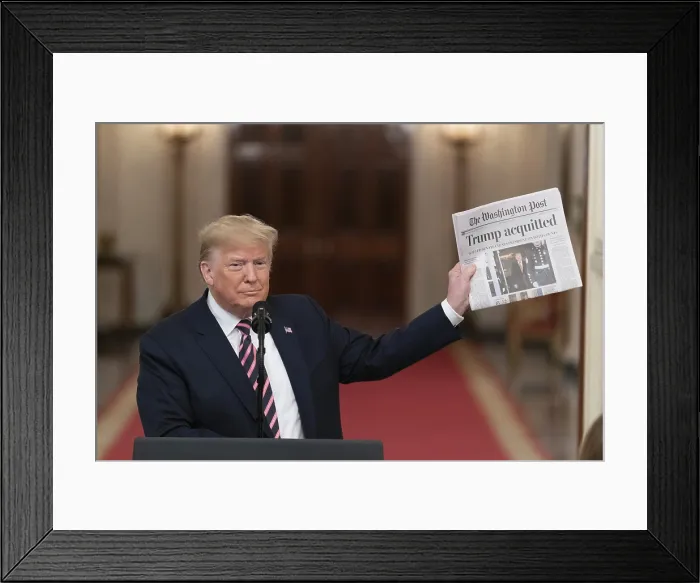 Framed Print : President Donald Trump holds up a Washington Post newspaper with the headline ACQUITTED at the East Room of the White House, Feb. 6, 2020