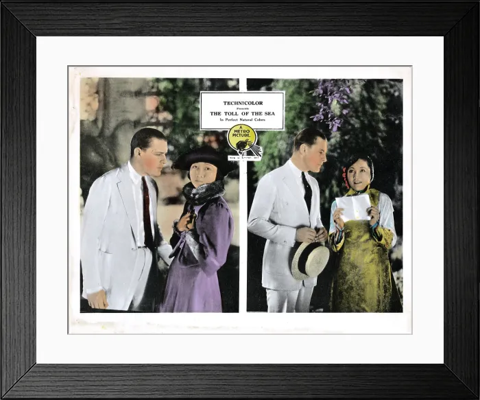 Framed Print : THE TOLL OF THE SEA, Kenneth Harlan (white suit), Anna May Wong (purple, and right), 1922