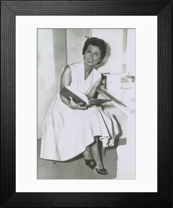 Framed Print : Nancy Barbato Sinatra, the divorced wife of Frank Sinatra reads a movie script in her Hollywood dressing room, Sept. 2, 1955