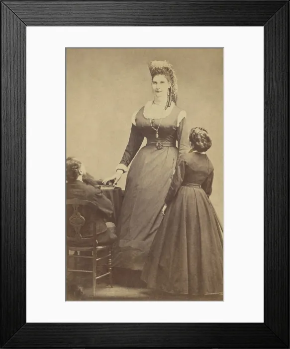 Framed Print : Female giant, Anna Haining, (aka Anna Swan), 7 feet, 11 inches tall, poses with two normal sized people, ca. 1865-70