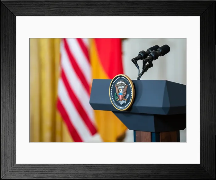 Framed Print : The US presidential seal hangs from a speakerless podium in East Room of the White House, Feb. 7, 2022 (BSLOC_2022_2_2)