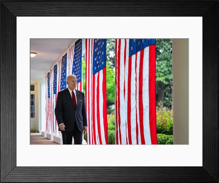 Framed Print : President Joe Biden walks along the flag lines West Colonnade of the White House, May 3, 2022. (BSLOC_2022_5_2) Framed Print : President Joe Biden walks along the flag lines West Colonnade of the White House, May 3, 2022. (BSLOC_2022_5_2)