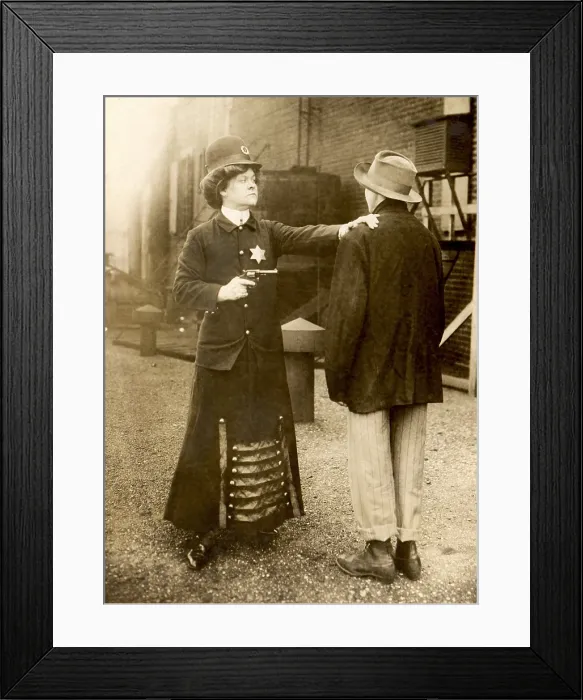 Framed Print : Fictional photo of a woman policeman arresting a man, Sept. 1909 Framed Print : Fictional photo of a woman policeman arresting a man, Sept. 1909