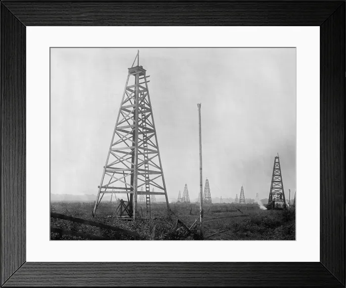 Framed Print : An American oil field with several derricks, c. 1900-1920. Unknown location. (BSLOC_2018_2_85) Framed Print : An American oil field with several derricks, c. 1900-1920. Unknown location. (BSLOC_2018_2_85)