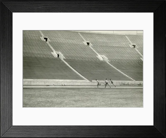 Framed Print : Relay racers practice baton handoff in an empty stadium, c. 1920. Unknown location (BSLOC_2018_4_200)