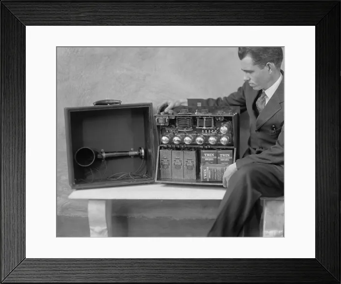 Framed Print : Electrical engineer, Brent Daniel, demonstrates his portable Super-Heterodyne radio. In 1925 he was able to receive Pacific Coast stations 3000 miles away