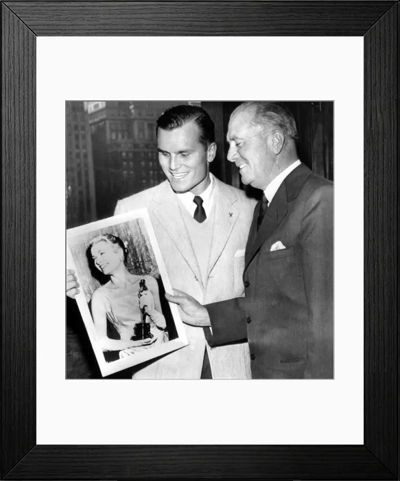 Framed Print : Jack Kelly Jr. and his dad, Jack Kelly Sr, admire a picture of Grace Kelly holding her Oscar. ca. March 1955. Courtesy: CSU Archives / Everett Collection
