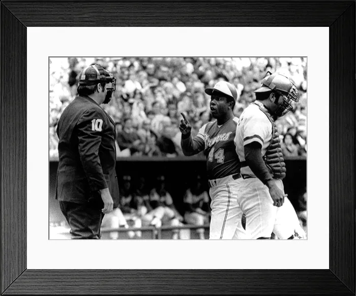 Framed Print : Umpire John McSherry listens to Hank Aaron argue a called third strike as catcher Johnny Bench looks down, 1974. Courtesy: CSU Archives  /  Everett Collection