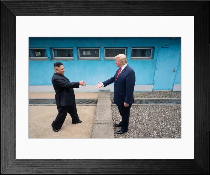 Framed Print : Kim Jong Un, leader of North Korea, approaches a waiting President Donald Trump, who extends his hand to Kim, across the boundary of North Korea and South Korea Framed Print : Kim Jong Un, leader of North Korea, approaches a waiting President Donald Trump, who extends his hand to Kim, across the boundary of North Korea and South Korea