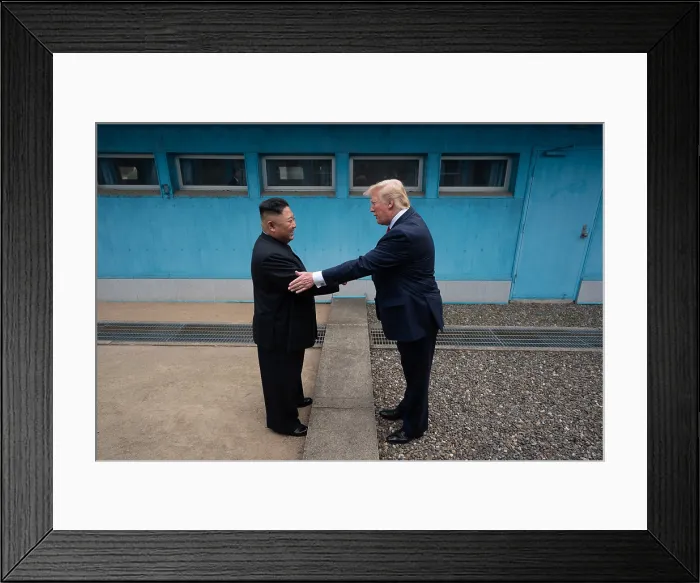 Framed Print : Kim Jong Un, leader of North Korea, accepts the greeting of President Donald Trump, across the boundary of North Korea and South Korea, in Demilitarized Zone. June 30, 2019