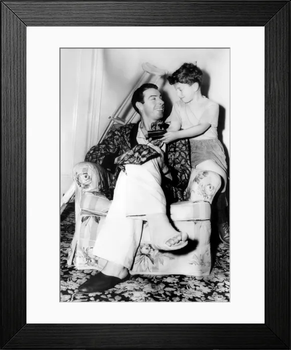 Framed Print : Joe DiMaggio, recovering from an operation on his right heel, shows his son Joe jr. a stauette given to him as a gift by the Rome Athletic Club in Italy. ca. December 1948 Framed Print : Joe DiMaggio, recovering from an operation on his right heel, shows his son Joe jr. a stauette given to him as a gift by the Rome Athletic Club in Italy. ca. December 1948