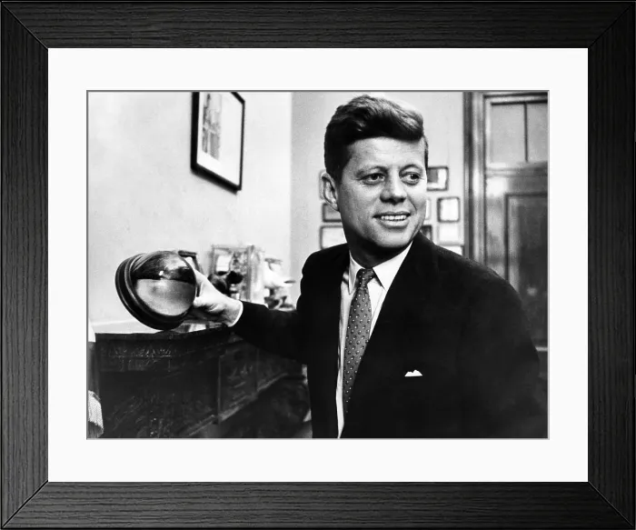 Framed Print : Senator John F. Kennedy, holds a mounted half of a cocoanut in his Senate office