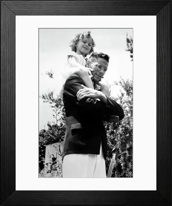 Framed Print : Shirley Temple being carried by her brother Jack Temple, 7 / 21 / 34. Courtesy: CSU Archives / Everett Collection Framed Print : Shirley Temple being carried by her brother Jack Temple, 7 / 21 / 34. Courtesy: CSU Archives / Everett Collection