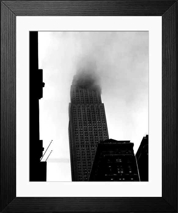 Framed Print : Smoke pours from the windows of the Empire State Building after a B-25 Bomber accidentally crashed into the 78th story. New York, New York. July 28, 1945
