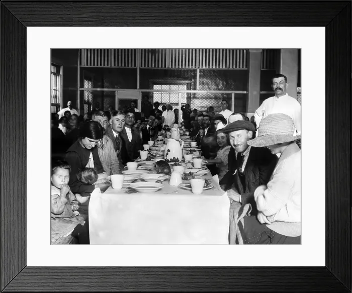 Framed Print : Immigrants who are awaiting approval of their entry into the U.S. crowd in the lunchroom for their noonday meal. Ellis Island, New York. ca. 1923