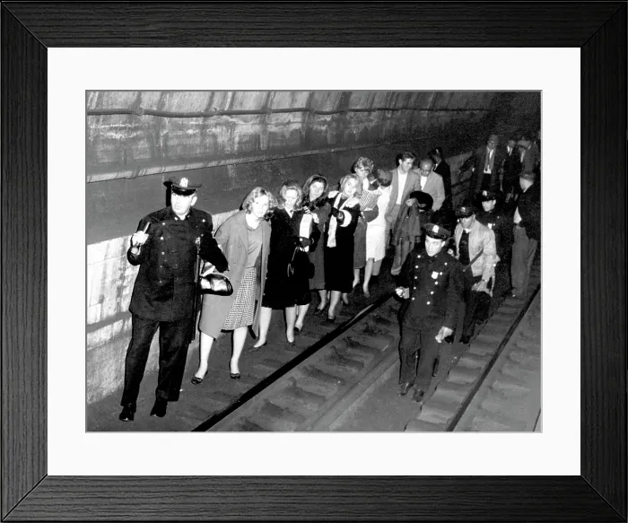 Framed Print : Policemen lead commuters through a subway tunnel. They were trapped here late on November 9th when a massive power failure stopped all trains