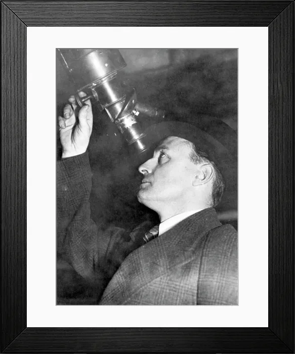 Framed Print : American astronomer Leslie Peltier, (1900-1980), looking through the telescope with which he discovered a new comet, January 19, 1939.. Courtesy: CSU Archives  /  Everett Collection