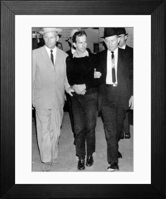Framed Print : Lee Harvey Oswald walks from the Dallas Police Station moments before he was shot, 1963. Courtesy: CSU Archives / Everett Collection