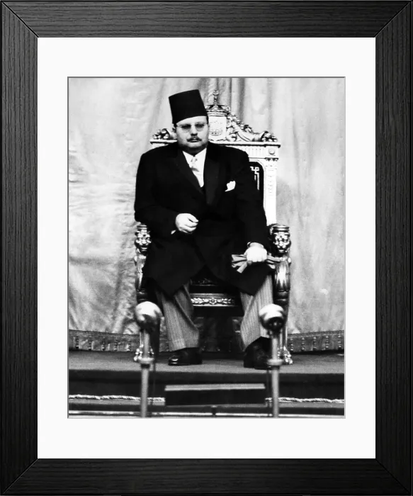Framed Print : King Farouk of Egypt (1920-1965), listens from his throne as the newly appointed Prime Minister Framed Print : King Farouk of Egypt (1920-1965), listens from his throne as the newly appointed Prime Minister