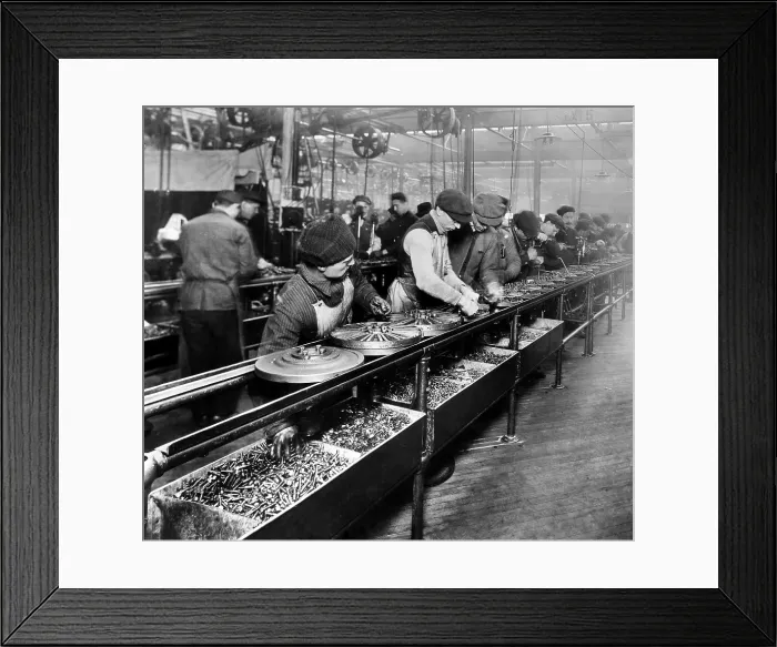 Framed Print : Men work on the flywheel magneto, the first manufactured part to be built on a moving assembly line, Ford Motor Company plant in Highland Park, Michigan, 1913