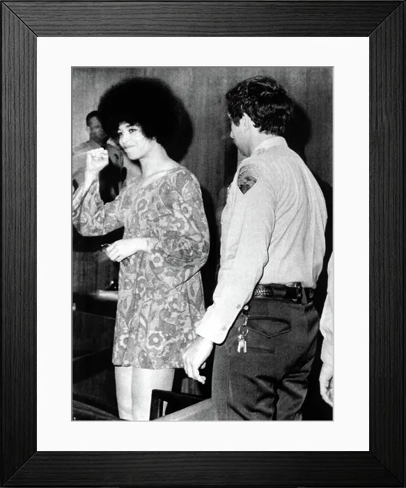 Framed Print : Black militant Angela Davis gives clenched fist salute as she appears briefly, Dec. 23, 1970 to face charges of conspiracy, kidnap and murder