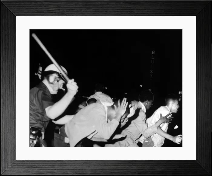 Framed Print : Police club demonstrators in Harlem on July 20, 1964. They were protesting the fatal police shooting of 15 year old James Powell four days earlier