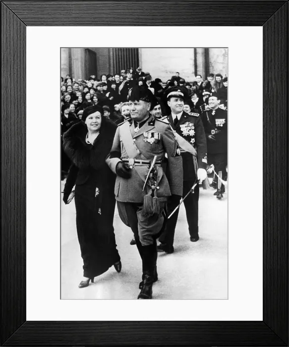 Framed Print : Benito Mussolini (center), after attending the wedding of his nephew. On his arm (left), is Signora DeRosa, mother of the bride. February 2, 1937 Framed Print : Benito Mussolini (center), after attending the wedding of his nephew. On his arm (left), is Signora DeRosa, mother of the bride. February 2, 1937