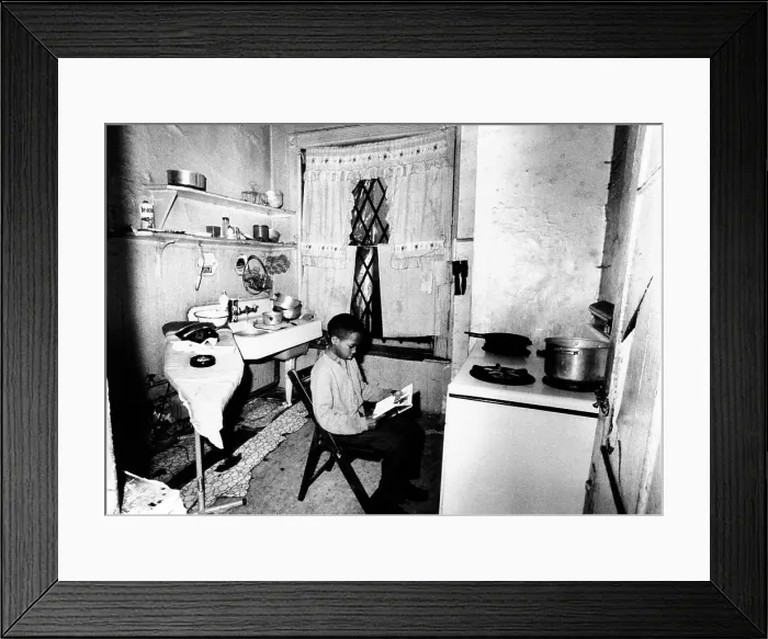 Framed Print : African American youth studies by the kitchen stove because his apartment, like the others in his buildings, is without heat Framed Print : African American youth studies by the kitchen stove because his apartment, like the others in his buildings, is without heat